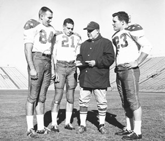 photo of Weeb Eubank with three football players