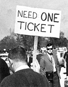 man holding sign needing a ticket