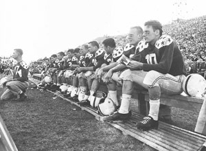 retro photo of football players on the sideline